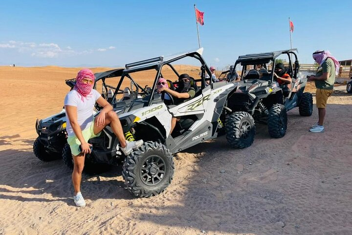 Experience the thrill of driving a 4x4 Polaris buggy across stunning desert dunes with expert guidance and all equipment provided to ensure an unforgettable adventure.